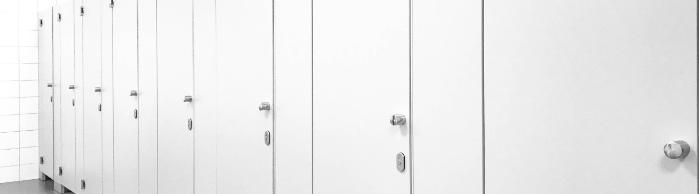 Public bathroom with a row of white stalls